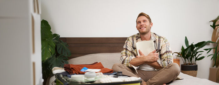 Portrait of young woman using digital tablet while sitting at home