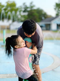 Side view of boy playing with ball in park