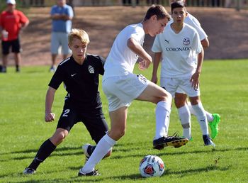 Men playing soccer on field