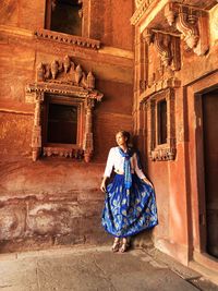 Full length of tourist standing by historical building