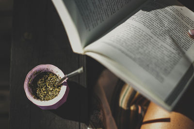 Low section of woman holding book
