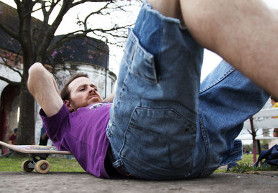 Portrait of skateboarder lying on the floor