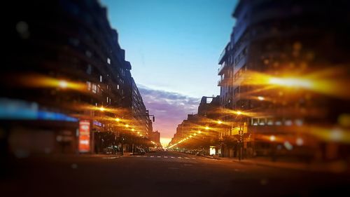 Illuminated city against sky at night