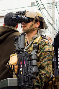 Portrait of man holding camera while standing in traditional clothing