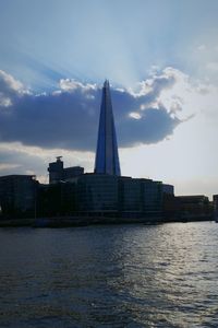 View of cityscape against cloudy sky