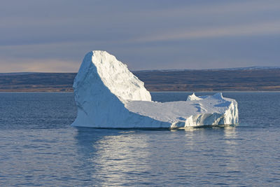 Distinctive iceberg off a remote coast in isabella bay on baffin island in nunavut, canada