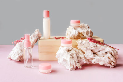 Close-up of pink roses on table against white background