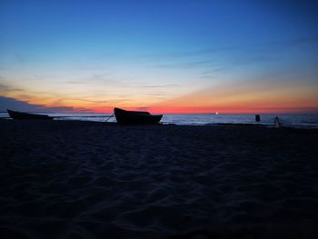 Scenic view of beach against sky during sunset