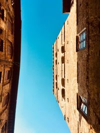 Low angle view of building against clear blue sky