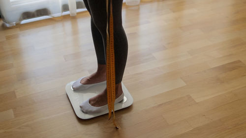 Low section of woman standing on floor