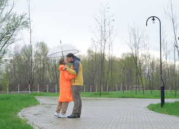 Rear view of woman standing on field