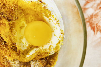 Chicken egg in bowl with flour and sugar , preparing food ,
