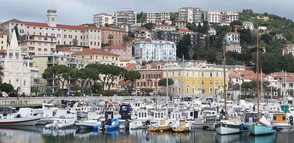 Boats moored at harbor in city