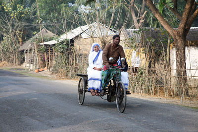 Man riding bicycle on road