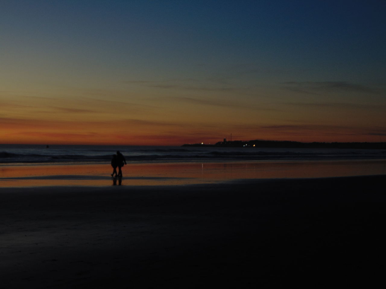 SILHOUETTE MAN STANDING AT BEACH DURING SUNSET