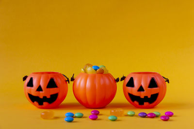 View of pumpkins against yellow background