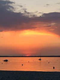 Scenic view of sea against orange sky