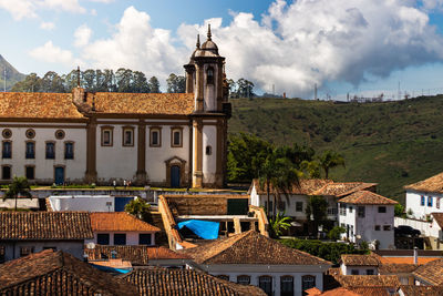 Buildings in town against sky