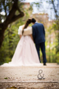 Rear view of couple walking on street