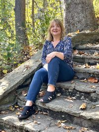 Full length of young woman standing in forest