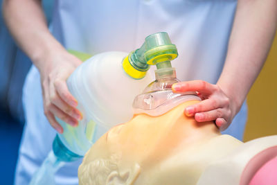 Midsection of doctor with cpr dummy