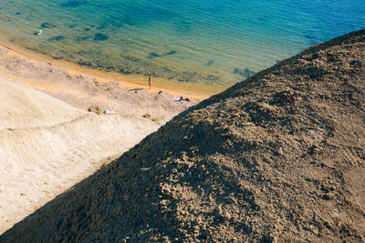 Distant view of woman standing on shore at beach