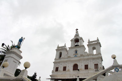 Low angle view of building against cloudy sky