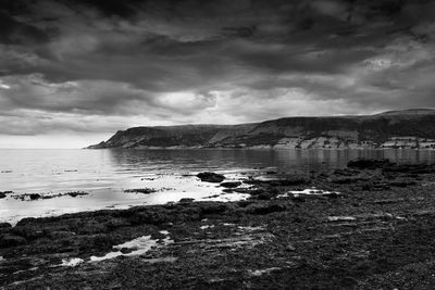 Scenic view of sea against cloudy sky