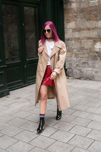 Portrait of young woman walking in city