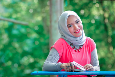 Portrait of young woman using mobile phone