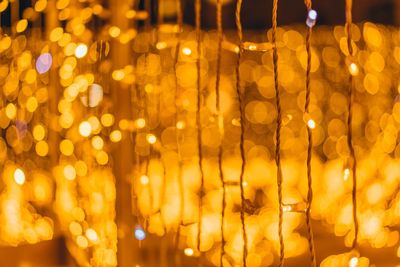 Defocused image of illuminated christmas lights at night