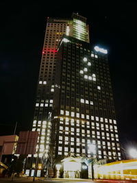 Low angle view of skyscrapers lit up at night