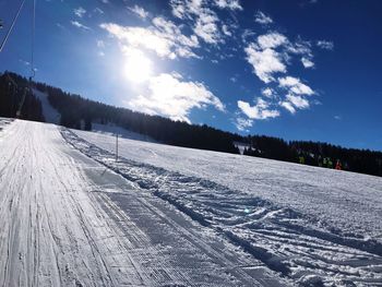 Snow covered land against sky