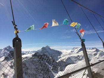 Scenic view of snowcapped mountains against blue sky