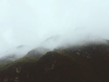 Scenic view of mountains in foggy weather
