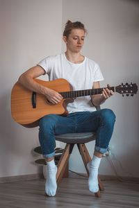 Full length of man playing guitar