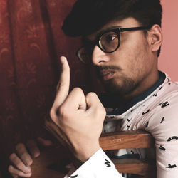 Close-up portrait of young man wearing eyeglasses