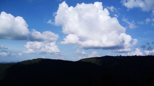 Scenic view of mountains against cloudy sky