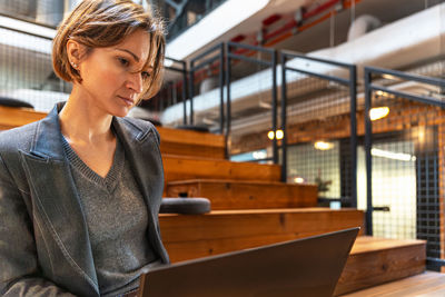 Portrait of young woman standing in cafe