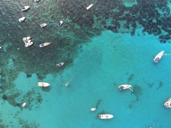 High angle drone view of boats in perfect water colors