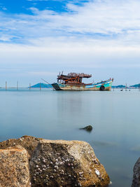 Scenic view of rocks in sea against sky