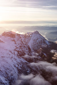 Scenic view of snowcapped mountains against sky during sunset