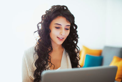 Young woman looking away while using mobile phone