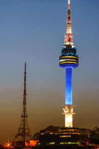 Low angle view of illuminated n seoul tower against sky during sunset