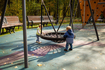 Siblings playing at playground