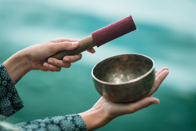 Cropped image of hands playing singing bowl