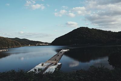 Scenic view of lake and mountains against sky