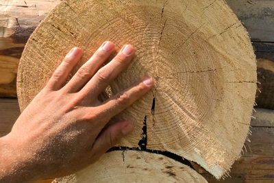 Close-up of person hand on wooden table