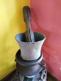 High angle view of old equipment on table against wall