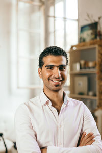 Portrait of smiling young man at home